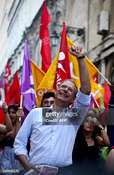 The leader of the left wing Bloco de Esquerda Party Francisco Louca gestures as he is surrounded by supporters on May 31, 2011 during a campaign...