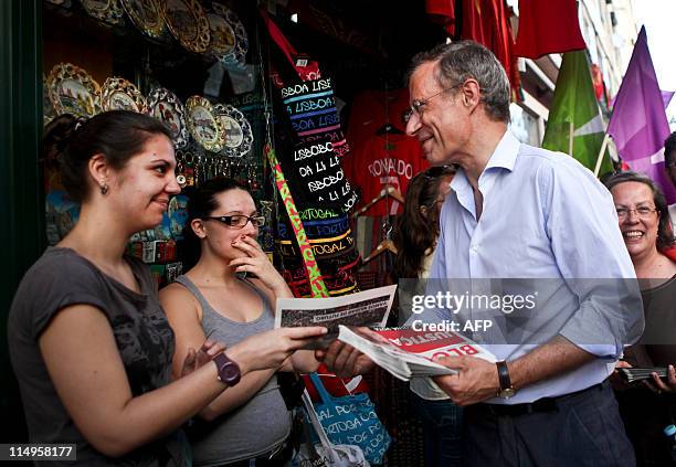 The leader of the left wing Bloco de Esquerda Party Francisco Louca gives flyers to people as he is mobbed by supporters on May 31, 2011 during a...