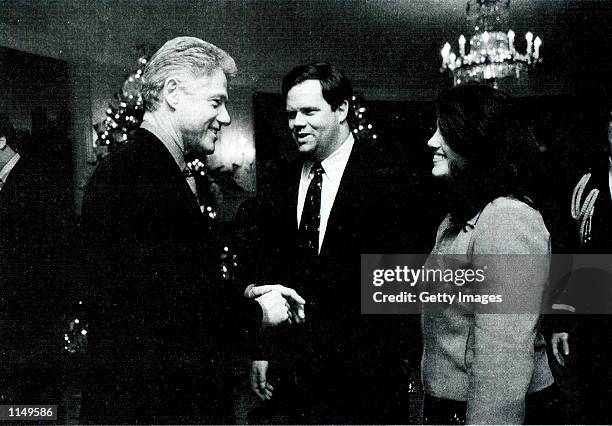 Photograph showing former White House intern Monica Lewinsky meeting President Bill Clinton at a White House Christmas part December 16, 1996...