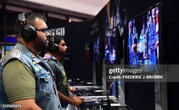 Gaming fans play "Judgement" from Sega at the 2019 Electronic Entertainment Expo, also known as E3, on June 12, 2019 in Los Angeles, California. -...