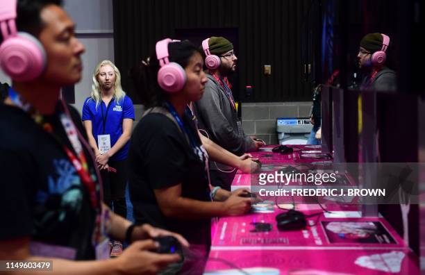 Gaming fans play "Catherine: Fullbody" from Atlus at the 2019 Electronic Entertainment Expo, also known as E3, on June 12, 2019 in Los Angeles,...