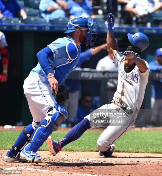 Danny Santana of the Texas Rangers scores past Cam Gallagher of the Kansas City Royals on a Willie Calhoun two-run single in the fifth inning at...