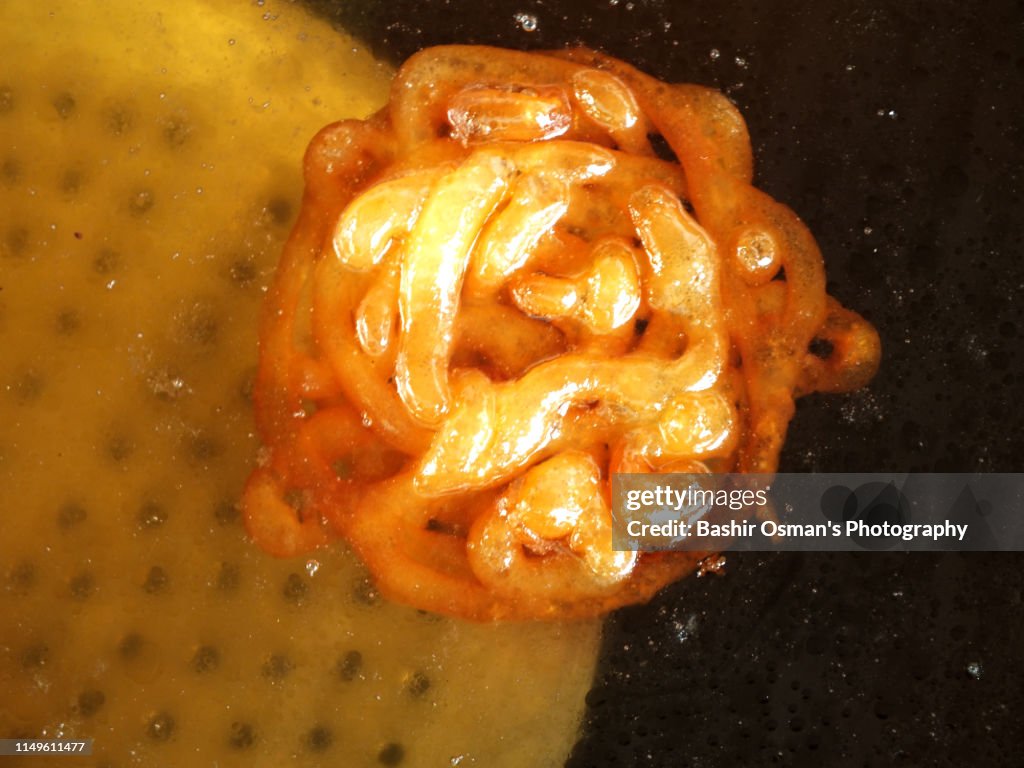 Jalebi and other snacks are on sale at a street of Karachi