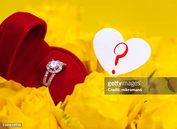 yellow roses with engagement ring and a heart and a question mark - anniversary mark stock pictures, royalty-free photos & images