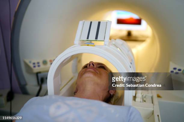 inside tube of mri scanner women receiving an mri scan. - cancer screening stock-fotos und bilder