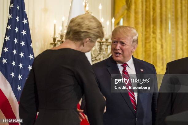 President Donald Trump, right, shakes hands with Agata Kornhauser-Duda, Poland's first lady, during a Polish-American reception in the East Room of...