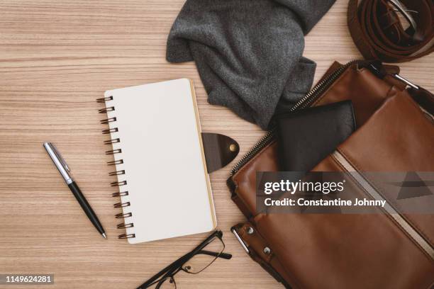 satchel men's bags and notebook on wooden desk - spiral notebook table stock pictures, royalty-free photos & images