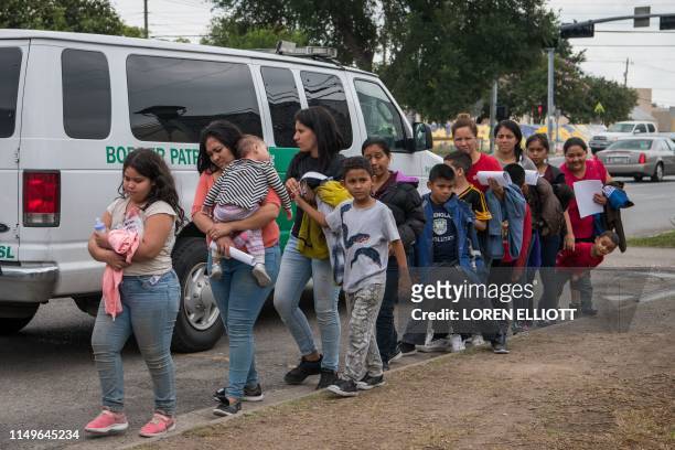 Central American migrant families arrive at a Catholic Charities respite center after being released from federal detention on June 12 in McAllen,...