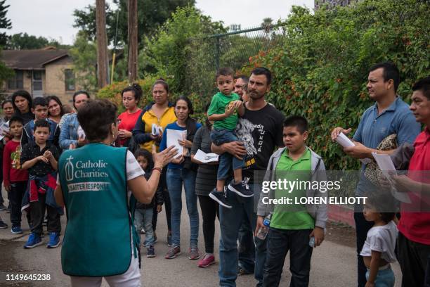 Central American migrant families arrive at a Catholic Charities respite center after being released from federal detention on June 12 in McAllen,...