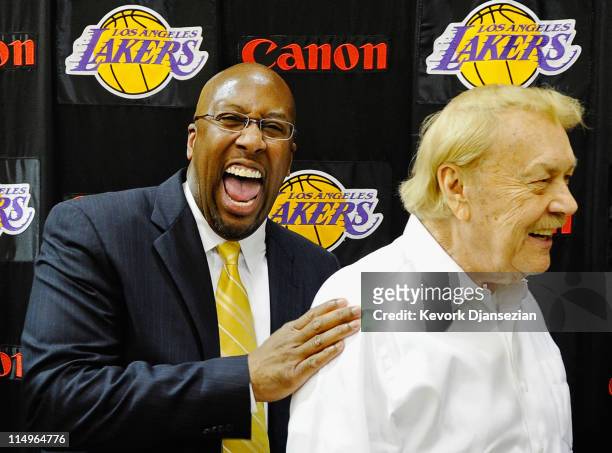 Mike Brown, the new head coach for the Los Angeles Lakers, laughs with team owner Jerry Buss after Brown's introductory news conference at the team's...