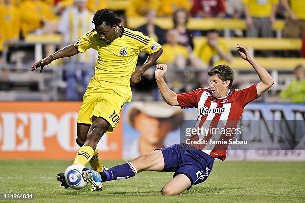 Andrew Boyens of Chivas USA reaches in to kick the ball away from Andres Mendoza of the Columbus Crew on May 28, 2011 at Crew Stadium in Columbus,...