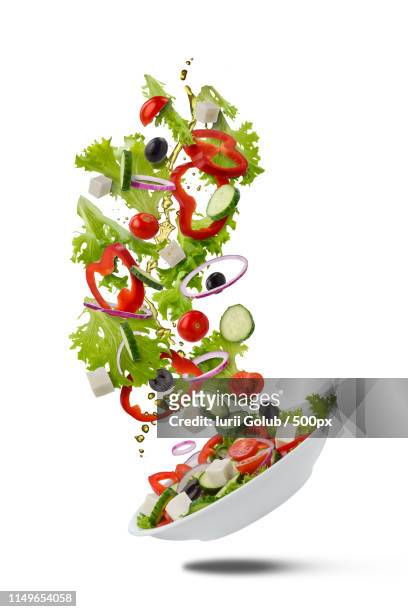 flying greek salad on white - throwing tomatoes stock pictures, royalty-free photos & images