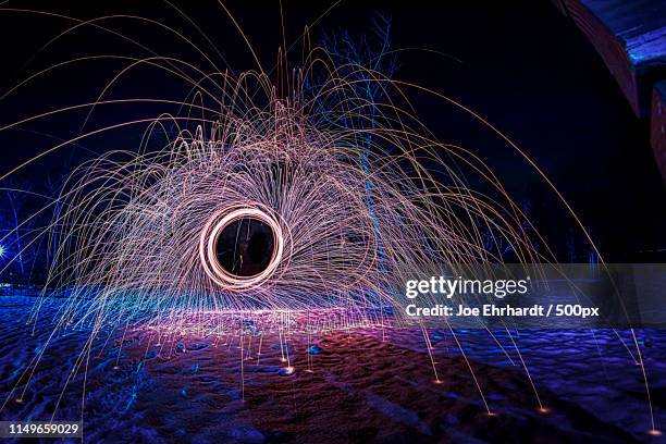 spinning fire - light art lapp - scouring pad stock pictures, royalty-free photos & images