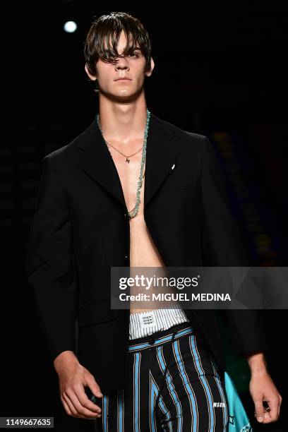 Model Leonardo Tano, the son of Italian pornographic actor Rocco Siffredi, presents a creation during the presentation of Italian fashion brand...