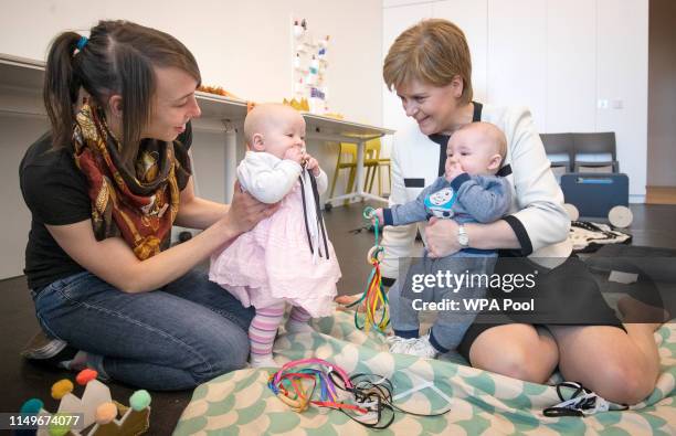 First Minister Nicola Sturgeon meets Staci Kenny with her daughter Emily MacPhearson, 6 months and Axel Laurie, 5 months, in the Home-Start Dundee...