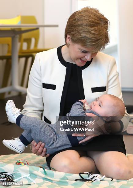 First Minister Nicola Sturgeon meets five-month-old Axel Laurie in the Home-Start Dundee pre-school group in the Thomson Learning Centre during a...