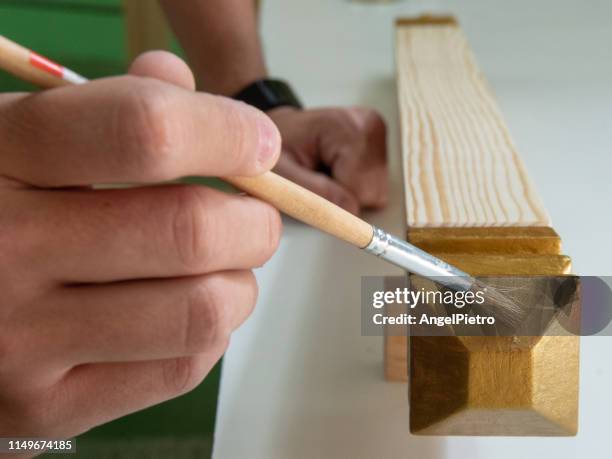 carpentry shop - painting a wooden piece - moldura stock pictures, royalty-free photos & images