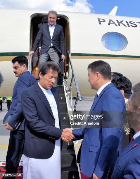 Pakistani Prime Minister Imran Khan is welcomed by Mukhammedkalyi Abylgaziev, Prime Minister of Kyrgyzstan and Kyrgyz Minister for Health Kosmosbek...