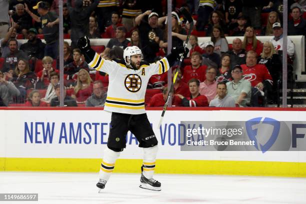 Patrice Bergeron of the Boston Bruins celebrates after scoring a goal on Curtis McElhinney of the Carolina Hurricanes during the third period in Game...