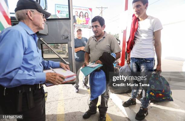 Guatemalan asylum seekers, a father and son, prepare to board a bus to meet their sponsors in Las Vegas after leaving a shelter for migrants who seek...