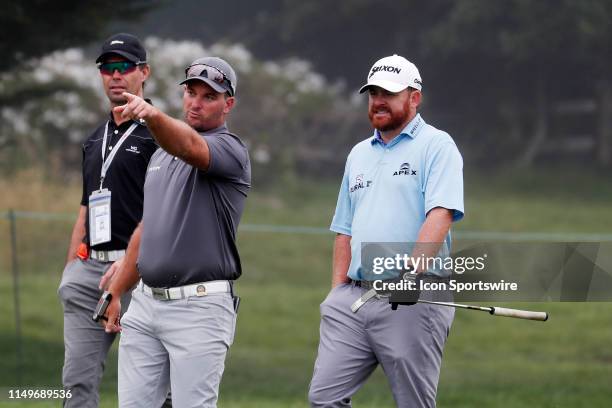 Golfer Ryan Fox on left talks to JB Holmes while playing the 15th hole during a practice round for the 2019 US Open on June 12 at Pebble Beach Golf...