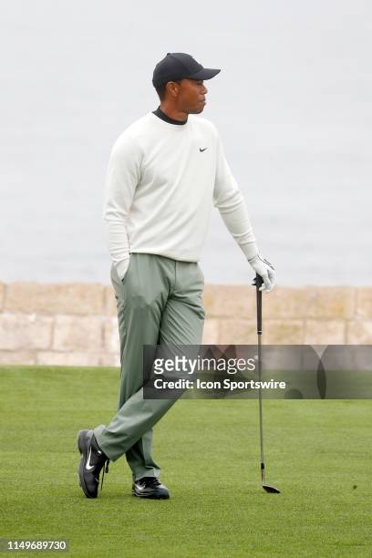Golfer Tiger Woods waits to play his shot on the 18th fairway during a practice round for the 2019 US Open on June 12 at Pebble Beach Golf Links in...
