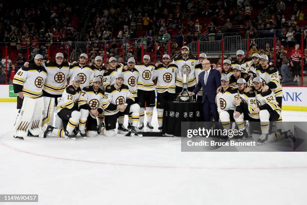 The Boston Bruins pose with the Deputy Commissioner Bill Daly and the Prince of Wales Trophy after defeating the Carolina Hurricanes in Game Four to...