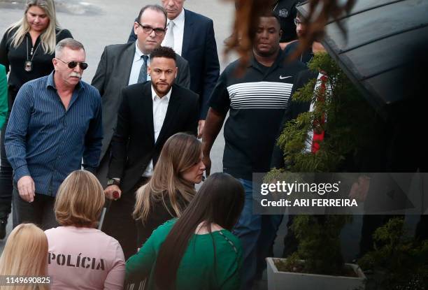 Brazilian football player Neymar arrives on crutches at the Women's Defence Precinct in Sao Paulo, Brazil on June 13, 2019 to testify after Brazilian...