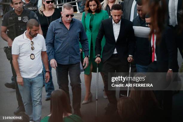 Brazilian football player Neymar arrives on crutches at the Women's Defence Precinct in Sao Paulo, Brazil on June 13, 2019 to testify after Brazilian...