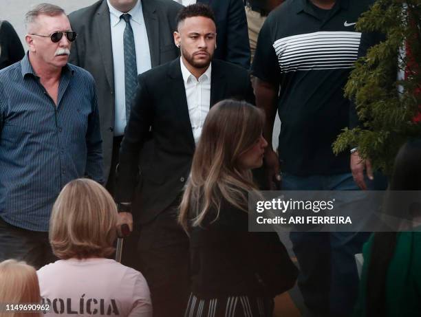 Brazilian football player Neymar arrives on crutches at the Women's Defence Precinct in Sao Paulo, Brazil on June 13, 2019 to testify after Brazilian...