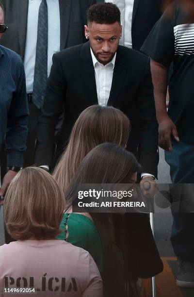 Brazilian football player Neymar arrives on crutches at the Women's Defence Precinct in Sao Paulo, Brazil on June 13, 2019 to testify after Brazilian...