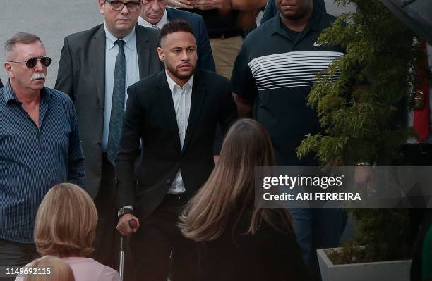 Brazilian football player Neymar arrives on crutches at the Women's Defence Precinct in Sao Paulo, Brazil on June 13, 2019 to testify after Brazilian...