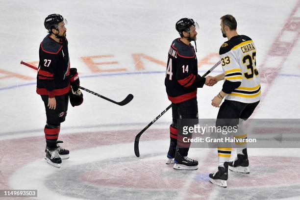 Zdeno Chara of the Boston Bruins shakes hands with Justin Williams of the Carolina Hurricanes after defeating the Carolina Hurricanes in Game Four to...