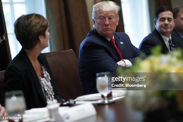 Kim Reynolds, governor of Iowa, left, speaks as U.S. President Donald Trump, listens during a working lunch with governors on workforce freedom and...