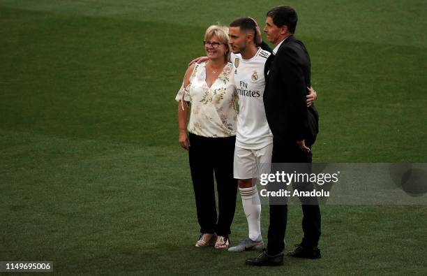 New signing of Real Madrid Eden Hazard poses for a photo with his mother Carine Hazard and his father Thierry Hazard during press release following...