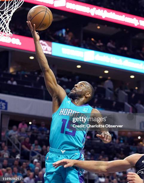 The Charlotte Hornets' Kemba Walker drives to the basket for two points during first-half action against the Orlando Magic at Spectrum Center in...