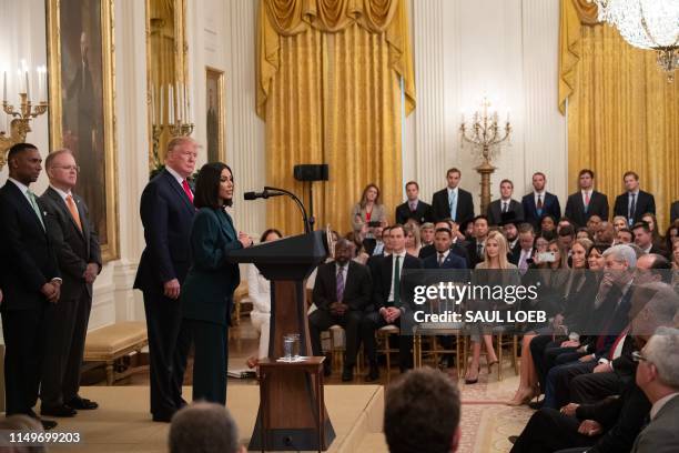 Kim Kardashian speaks alongside US President Donald Trump during a second chance hiring and criminal justice reform event in the East Room of the...