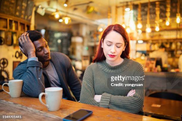 young couple having an argument in a cafe - cheating boyfriend stock pictures, royalty-free photos & images