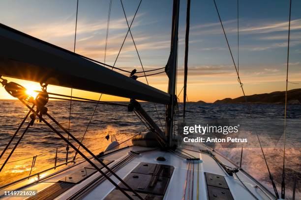 yacht sailing at sunset during a storm. luxury vacation at sea - regata imagens e fotografias de stock