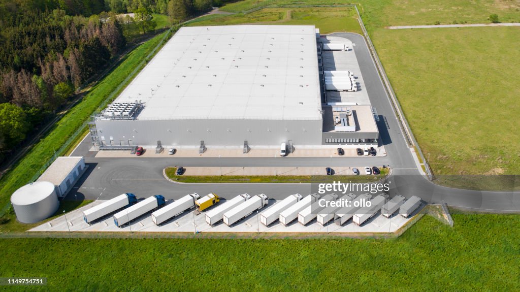 Loading bay, truck parking lot, industrial building, logistics - aerial view