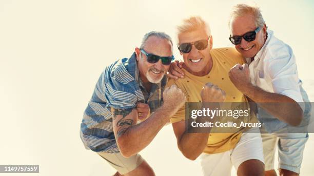 flexing their summer muscles - group of people flexing biceps stock pictures, royalty-free photos & images