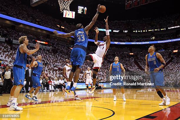 Chris Bosh of the Miami Heat shoots over Brendan Haywood of the Dallas Mavericks in the second half in Game One of the 2011 NBA Finals at American...