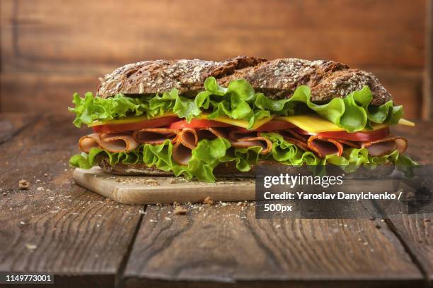 sandwich on the wooden table - sandwich stock-fotos und bilder