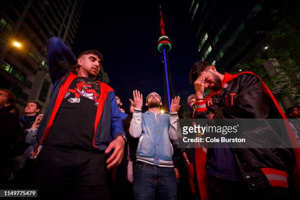 Fans stand in dejection after a Golden State basket as Toronto Raptors fans gather to watch Game Six of the NBA Finals outside of Scotiabank Arena on...