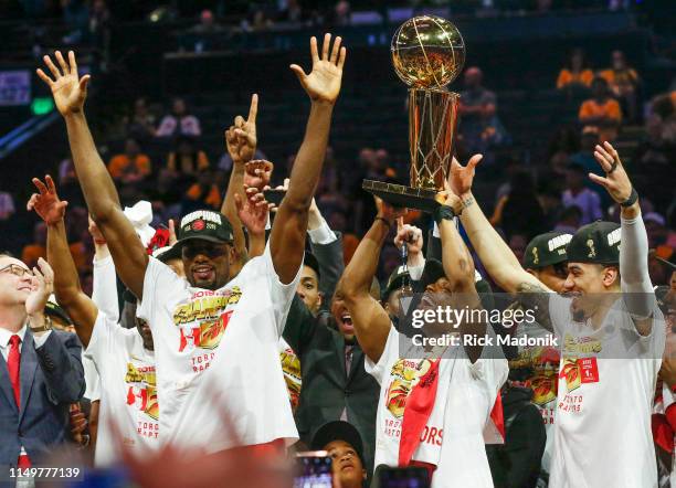 Toronto Raptors guard Kyle Lowry hoists the trophy with Toronto Raptors center Serge Ibaka and Toronto Raptors guard Danny Green (right. Toronto...