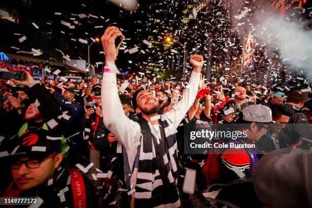 Toronto Raptors fans cheer after the Raptors defeat the Golden State Warriors in Game Six of the NBA Finals outside of Scotiabank Arena on June 13,...