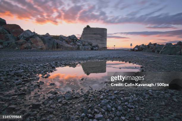 quarry silo puddle reflection - mining low angle foto e immagini stock