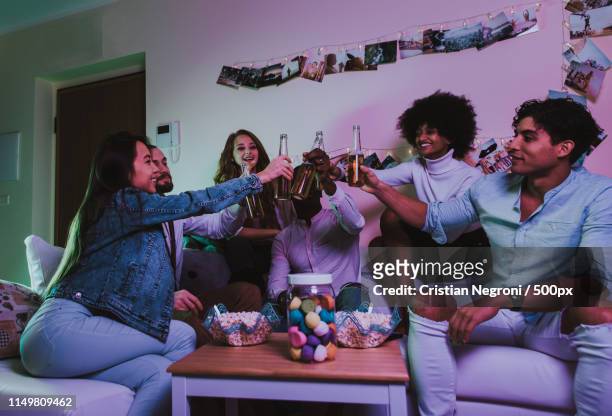 a group of young people celebrating and making party at home - drunk wife at party stockfoto's en -beelden