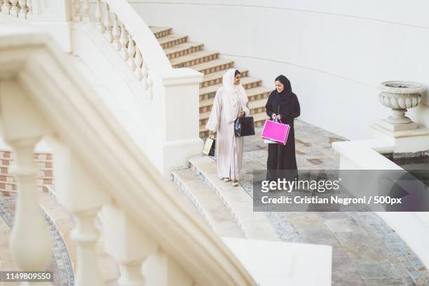 two arabian women spending time together - qatar port stock-fotos und bilder