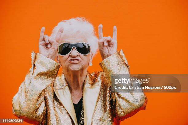 grandmother portraits on colored backgrounds - cantante rock foto e immagini stock